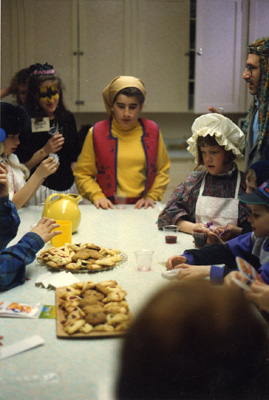 Student rabbi Amy Memis (far left) with Temple kids, ready for Purim treats, 1993.