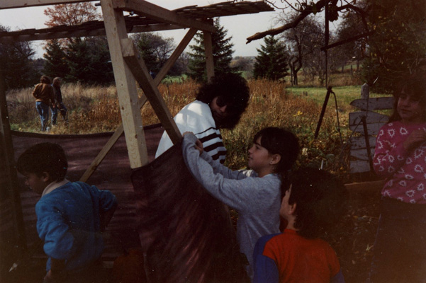 Wendy Weinberg helps secure the succah erected at the Golds’ farm, 1989