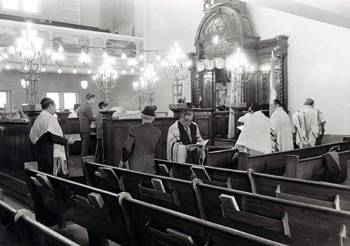 Men praying during services in the Kiever sanctuary