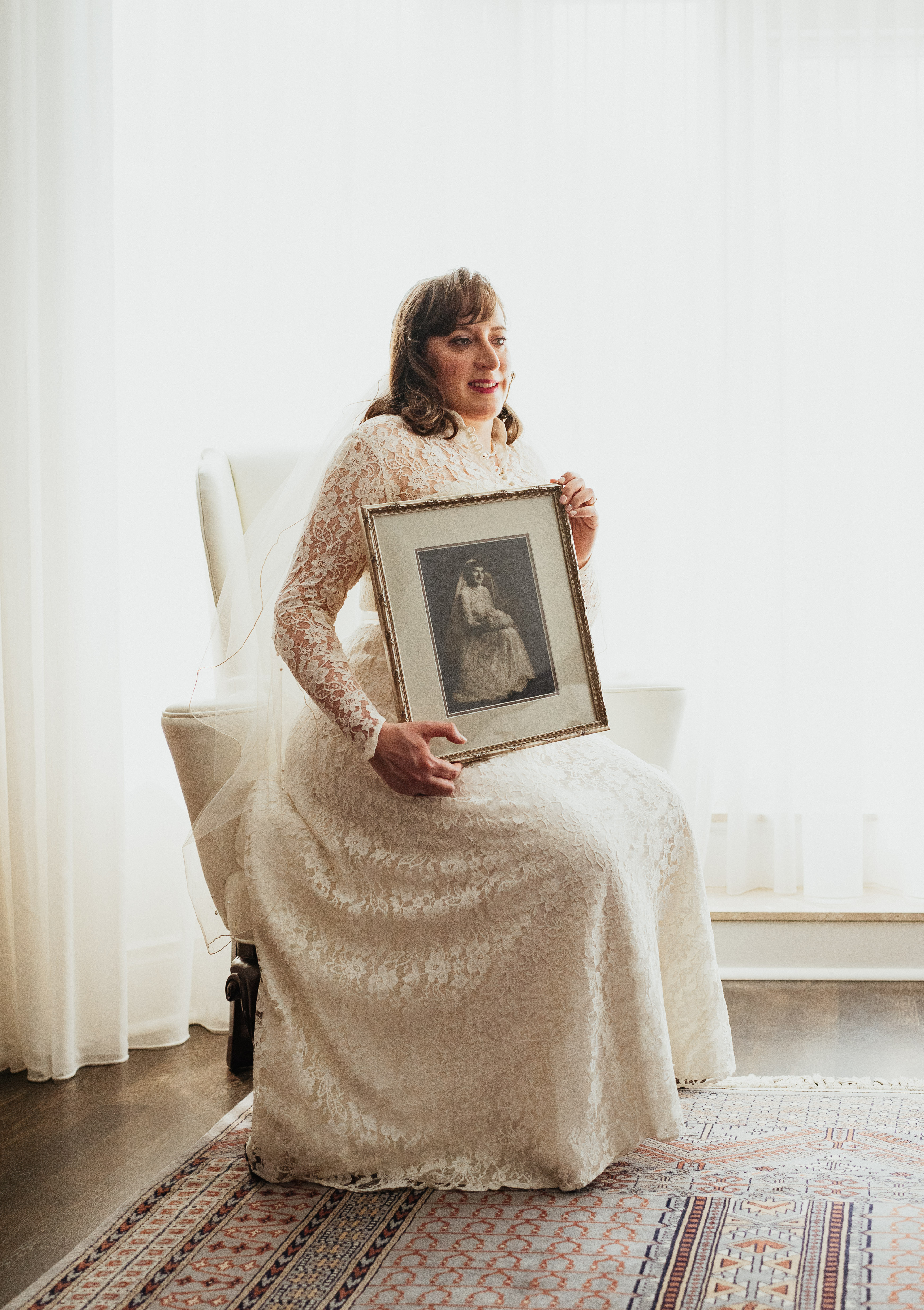 Sam Mogelonsky holding wedding portrait of her grandmother