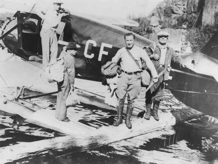 Jack Leve with three co-workers and a float plane, 1921