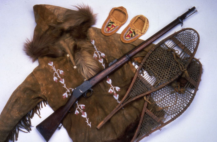 Jack Leve's snowshoes and Martini Enfield rifle with a beaded parka and moccasins, ca. 1915
