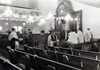 Men praying during services, April 12, 1974