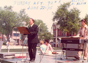 Cantor H. Klein sings to his audience during a concert held in Denison Square