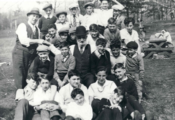 Fischel Cooper and youngsters associated with the Kiever on an outing in the park, c. 1938. 