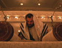 Rabbi Shmuel Spero reads the Torah scroll in the Minsk shul, 2001.